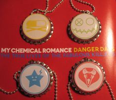 four bottle caps with the words, my chemical romance dangerous kids on them are attached to a chain