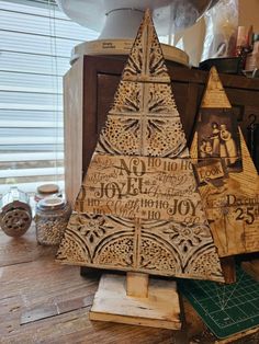 a wooden christmas tree sitting on top of a table