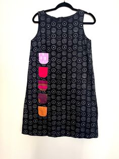 "Marimekko  Kihlatasku Iloinen Takki or \"cheerful coat\" dress, originally designed by Vuokko Nurmesniemi in 1959, size 34, sundress style.  Adorable sundress version of iconic Marimekko Iloinen Takki dress. Dress features back zip, a-line silhouette, 5 colorful functional front pockets, and is fully lined. Perfect for summer days out and about.  Dress is 100% cotton. Size is 34, but due to shape, would best fit up to a size 6. Excellent vintage condition with no flaws noted! Every Marimekko lo A-line Cotton Dress With Side Pockets, Mod Sleeveless Dresses With Buttons, Black Cotton Dress With Side Pockets, Multicolor Cotton Mod Dress, Multicolor Mod Cotton Dresses, Sundress Style, Oak Park, Out And About, Days Out