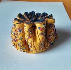 a small yellow purse sitting on top of a table