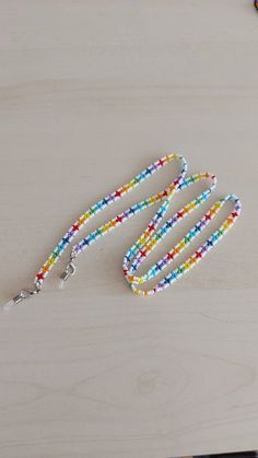 a multicolored beaded lanyard on a wooden table