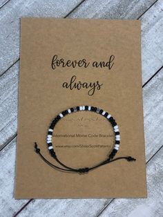 "Always and Forever" Morse Code Bracelet. A daily reminder that you are with your special recipient.  This bracelet is made with high quality, black waxed cotton cord - which is durable and lightweight. Beautiful black & white glass seed beads are used for your message.  Bracelet is adjustable with a sliding knot that fits most wrist sizes. Bracelet comes shipped with card stock packaging as shown.  Want a customized morse code bracelet? Message me and I can create it for you! Minimalist Personalized Black Friendship Bracelets, Minimalist Black Friendship Bracelets For Best Friend, Meaningful Black Jewelry For Mother's Day, Inspirational Black Jewelry For Everyday Wear, Black Friendship Bracelets For Mother's Day, Inspirational Black Bracelets For Everyday, Inspirational Black Friendship Bracelets, Black Friendship Bracelets, Minimalist Black Friendship Bracelets