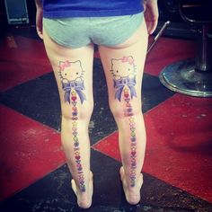 the legs of a woman with hello kitty tattoos on them