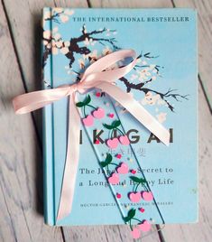 a book with a pink ribbon tied around it