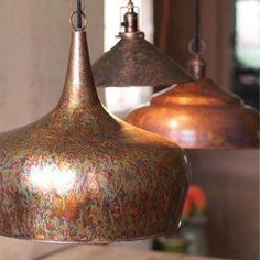 two copper colored lights hanging from a ceiling