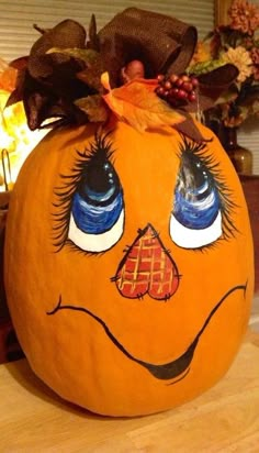 a pumpkin with eyes painted on it sitting on a table