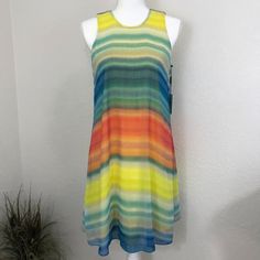 Calvin Klein Dress. Sleeveless A-Line Multi Colored Dress. Has A Thread Run On The Front Of The Dress. Brand: Calvin Klein Size: 4 Color: Yellow/Blue Multi Color Approximate Measurements: Length 36in (Shoulder To Hem) Bust 19in (Flat Across) Waist 18.5in (Flat Across) Material: Polyester Flowy Multicolor Sleeveless Dress For Spring, Colorful Sleeveless Sundress For Spring, Colorful Sleeveless Spring Sundress, Multicolor Sleeveless Lined Dresses, Vibrant Sleeveless Summer Dresses, Vibrant Sleeveless Sundress, Colorful Casual Sleeveless Spring Dress, Casual Colorful Sleeveless Dress For Spring, Vibrant Multicolor Sleeveless Sundress