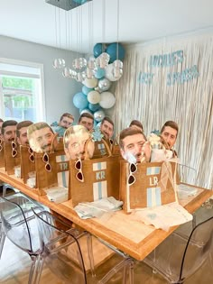 a group of people with paper bags in front of them that have faces on them