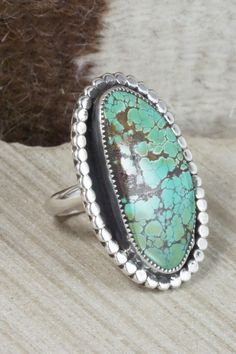 This turquoise and sterling silver ring was made by Navajo silversmith Priscilla Reeder. The back is signed PR and stamped sterling.Size: 9.5Length: 1 3/4"Width: 1 1/8"Free shipping on all orders! We ship with USPS and always include tracking. All orders ship within a day of payment.Returns are accepted up to 30 days after you receive your order. Just send us a message. Our shop offers cash back or store credit. The item must be returned in new condition. Western Sterling Silver Turquoise Ring With Patina, Artisan Turquoise Ring With Large Stone In Sterling Silver, Western Green Turquoise Ring In Sterling Silver, Oval Turquoise Ring With Sterling Silver Inlay, Turquoise Rings, Native American Jewelry, Turquoise Sterling Silver, Free Jewelry, Sterling Silver Ring