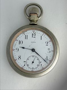 "Regina Omega J.W Dayman Antique Railroad Pocket Watch Porcelain Dial swiss Made Regina pocket watches were a brand of pocket watches made by Omega that were popular in the early 1900s. The name Regina Pocket Watch was originally trademarked by LOUIS MAIER in Bienne Switzerland in 1888. The name was then trademarked by Omega in 1911, indicating that they bought the company at that time. The faces and mechanisms were imported into New York and assembled with cases in Ontario, for sale mostly in C Vintage White Round Watches, Vintage White Chronograph Watch Accessories, Classic Round Stopwatch Watch, Classic Round Watch With Stopwatch, Old Records, Pocket Watch Antique, Pocket Watches, Beautiful Watches, Early 1900s