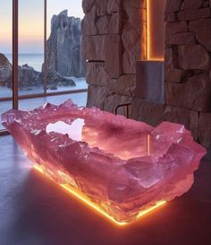 a large pink stone bowl sitting on top of a table next to a window with lights