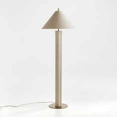 a lamp that is on top of a white surface with a cord attached to it