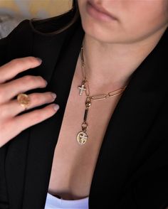 "You've reached our latest OBSESSION! We love this look to pair with other gold necklaces or just to be worn alone as a statement. Have fun with your gold, we always do! * DETAILS * ✤ Available in 14k Gold plated over brass ✤ Model is wearing 18\" With 3\" Drop ✤ Drop has Bar, cross set with swarovski crystal and virgin mary charm ✤ Available in Size 16\" 18\" and 20\" with 3\" charm drop - Purchase is packaged in a Tommassini Jewelry gift box. - Orders with multiple pieces will be shipped in on Charm Chain Link Necklaces, Gold Chain Link Necklace With Charms, Emily May, Latest Obsession, Chunky Chain Necklace, Tiny Cross, Chunky Chain Necklaces, Heavy Chain, Y Necklace