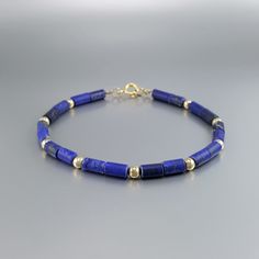 "Matte Lapis Lazuli bracelet with 14K gold plated beads and clasp. Unique gift for her or him, girlfriend, wife, September and December birthstone, 9 year anniversary. Beautiful bracelet with matte Lapis Lazuli tubes and Sterling silver 14K gold plated beads. The stones are arranged 2 to 1 with the metal parts. The stones are strung on stainless steel and finished with a Sterling silver 14K gold plated clasp. All our stones are natural stones and our jewelry handmade, slight differences in color 9 Year Anniversary, Lapis Lazuli Bracelet, Unique Gifts For Her, December Birthstone, Year Anniversary, Jewelry Handmade, Gold Beads, Beautiful Bracelet, Lapis Lazuli