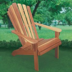 a wooden chair sitting on top of a lush green field