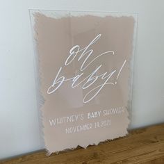 an acrylic sign with the words oh baby written in cursive writing