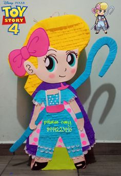 the paper doll is made to look like she's holding a large blue object