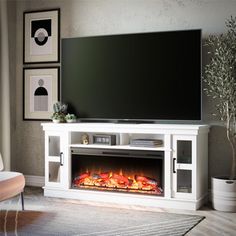 a living room with a large television and fire place in front of the flat screen tv