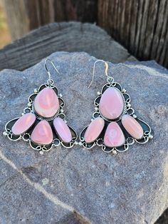 Add a touch of oceanic beauty to your look with our Pink Conch Shell Daggling Fan Earrings! Made from genuine pink conch shell, these earrings feature a unique daggling fan design that will catch everyone's eye. Perfect for adding a pop of color and personality to any outfit. Pink Bohemian Sterling Silver Earrings, Bohemian Pink Sterling Silver Earrings, Bohemian Shell-shaped Pink Jewelry, Bohemian Pink Shell-shaped Jewelry, Pink Teardrop Chandelier Earrings, Nickel Free, Fan Design, Fan Earrings, Kids Earrings, Conch Shell