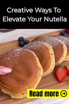 three pancakes with powdered sugar and strawberries on a cutting board next to the words creative ways to elevate your nutella