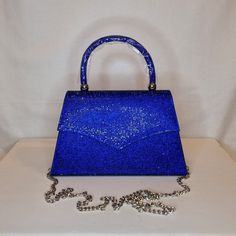 Womens royal cobalt blue crystal encrusted luxury evening clutch bag with silver embellishment, metallic satin finish material and magnet front closing top  Can be used with or without long shoulder chain (included) size approx- H 13cm x W 22cm Free Royal Mail delivery is an estimated 3-5 days but this can occasionally be slightly longer which solely on the Royal Mail side. We do offer guaranteed next day delivery but please contact us prior to ordering as this would incur a small upgraded shipping charge. We also offer WORLDWIDE shipping - please contact us for more info 💕🌍 Blue Rhinestone Evening Bag For Party, Glamorous Blue Bags With Rhinestones, Elegant Blue Bag For Night Out, Blue Evening Bag With Rhinestones, Glamorous Blue Evening Bag For Party, Royal Blue Rectangular Evening Bag, Blue Glamorous Bags For Events, Blue Rhinestone Clutch For Party, Glamorous Blue Bags For Events