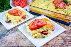 two square plates with food on them next to a casserole dish and tomatoes