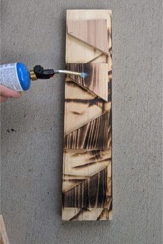 a person using a drill to paint wood