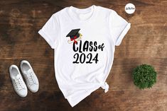 Celebrate your accomplishment in style with this Class of 2024 T-shirt! Perfect for graduating seniors, this Graduation 2024 Shirt is designed to commemorate your success and showcase your pride. Whether you're heading off to college or starting a new chapter in life, this Back to School Shirt is the perfect addition to your wardrobe. Stand out from the crowd with this unique High School Tee that showcases your graduating class in a stylish and trendy way. Get yours now and show the world that y Cotton Graduation T-shirt, Cotton T-shirt For Graduation, White Letter Print Top For Graduation Gift, White Tops With Letter Print For Graduation Gift, Crew Neck T-shirt For Graduation Party, White T-shirt With Letter Print For Graduation, White T-shirt With Letter Print As Graduation Gift, White Short Sleeve T-shirt For Graduation Gift, Cotton T-shirt For Graduation Party