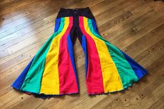 Rainbow bell bottoms, size Small. ❤️DESCRIPTION: One of a kind, 100% recycled. Go with the flow! 5 beautiful colors in these retro bell bottom pants: red, yellow, green, and blue on a deep purple background. Completely deconstructed and redesigned. Gorgeous reconstructed wide leg pants in cotton denim.  How will you rock them? 💛MEASUREMENTS: * Small, size 6 * 26.5 inch waist * 37.5 inch hips * 29 inch inseam * 100% recycled cotton 💚SHIPPING: Immediate shipping worldwide; buy with confidence. ? 70s Rainbow Outfit, 70s Rainbow Fashion, Retro Multicolor Wide Leg Bottoms, Retro Multicolor Bottoms With Patchwork, Cotton Flare Pants For Festivals, Retro Wide Leg Pants For Festival, 70s Inspired Wide Leg Festival Pants, Hippie Flare Cotton Bottoms, Retro Multicolor Bottoms For Festival