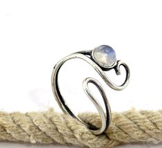 "Adjustable moonstone ring, Moonstone silver ring, Bohemian jewelry, Boho rings, Open ring. This everyday ring comes in many difrent stones 🌸 Features: Handmade ring 🌸 Measurements: Weight - 1.8g Width of the ring at the top - 0.57\" (1.45 cm) Stone diameter - 0.2\" (5 mm) 🌸Materials: Sterling Silver Moonstone 🌸 More info: All my jewelry is carefully wrapped and shipped in a lovely gift box, ready to be given as a gift. ♥ For the same ring design with a garnet, click here: www.etsy.com/listi Adjustable Silver Moonstone Crystal Ring, Adjustable Spiritual Moonstone Toe Ring, Adjustable Silver Moonstone Toe Ring, Adjustable Silver Moonstone Ring, Adjustable Silver Moon-shaped Moonstone Ring, Silver Moonstone Stackable Open Rings, Adjustable Moonstone Open Stackable Rings, Adjustable Moonstone Ring Stamped 925, Moonstone Stackable Open Rings