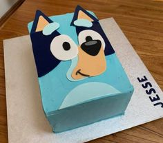 a blue cake with a dog face on it