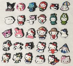 a bunch of hello kitty stickers sitting on top of a white table next to each other