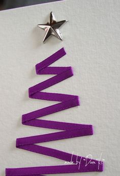 a christmas tree made out of strips of purple ribbon with a star on the top