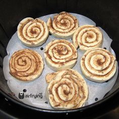 several cinnamon rolls sitting in an air fryer