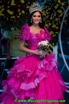 a woman in a pink dress and tiara