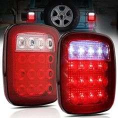 two red and white lights on the tail lights of a truck with an suv in the background