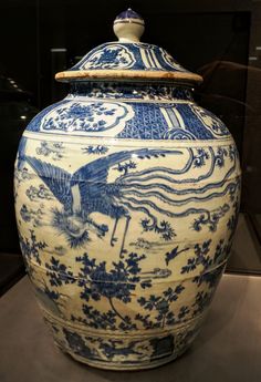 a large blue and white vase sitting on top of a table