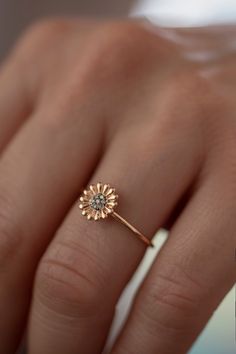 Feeling bohemian? Take this ultra feminine minimalistic boho daisy ring and declare yourself a champion of laid back cool. Handmade to order in 14K solid Rose Gold with a delicate band, this is not your ordinary daisy motif. Flower power is here to stay and has never looked so good! This is a modern way to wear floral jewelry as imagined by Atelier Petites Pierres, proprietors of beautiful jewelry fashioned from high quality materials and craftsmanship. A fourteen petal design sculpted in light Flower Shaped Rings With Rose Cut Diamonds For Gift, Flower Shaped Rose Cut Diamond Rings For Gifts, Dainty Flower Shaped Ring For Promises, Dainty Flower Shaped Promise Ring, Rose Gold Flower Ring For Promise, Birth Flower Ring For Promise, Dainty Flower Ring With Rose Cut Diamonds As Gift, Fine Jewelry Flower Promise Ring, Promise Flower Ring In Fine Jewelry Style