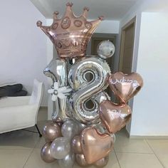 a large number balloon arrangement with balloons in the shape of numbers and crowns on it