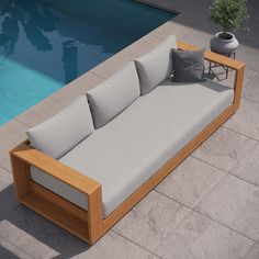 a couch sitting next to a swimming pool