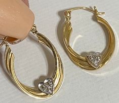 "Beautiful 14K Yellow Gold 1\" Diamond Heart Hoop Earrings Beautiful hoop earrings with a heart on bottom of hoop with genuine diamonds! Earrings measure approximately 1\" long x 6/8\" wide. Weight is 2.2 grams Absolutely beautiful! Please message me with any questions Shipped insured in a gift box I guarantee item to be exactly as described and pictures." Black Opal Pendant, Diamonds Earrings, Heart Hoop Earrings, Black Gift Boxes, Opal Pendants, Heart On, Star Pendant, Black Opal, Diamond Heart