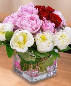 a vase filled with flowers on top of a wooden table