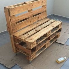 a wooden bench made out of pallets on the ground