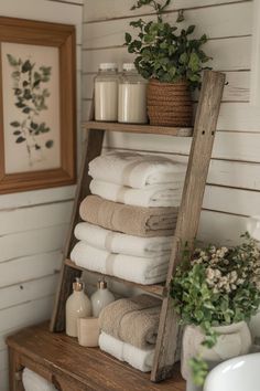 towels are stacked on top of an old ladder