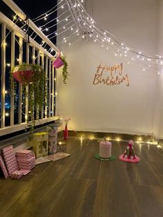 the room is decorated with fairy lights and presents on the floor, along with other decorations