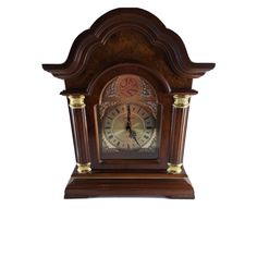 an old fashioned wooden clock with roman numerals on the front and sides, against a white background