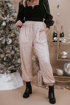 Make an entrance in this sleek yet chic sequin jogger. This captivating sequin jogger features a relaxed true to size fit, met with full sequin detailing throughout and functional side pockets. Waist: High rise/Elastic Fabric: 100% Polyester, Contrast: 95% Polyester, 5% Spandex; Lining: 100% Polyester Details: Lined, full sequin detailing, cinched ankle detail, functional side pockets Imported Fit: This jogger is a relaxed true to size fit!- Waist: High rise/Elastic- Leg: Jogger style fit- Has s Anthro Aesthetic, Jollywood Nights, Sequin Joggers, Everyday Chic, Elastic Fabric, Fashion Joggers, Chic Boutique, Displaying Collections, Champagne