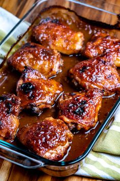 baked chicken wings with bbq sauce in a casserole dish on a wooden table