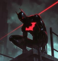 a batman statue sitting on top of a building with red laser beams in the sky