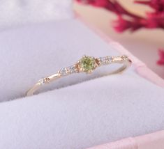 Small & dainty peridot promise ring for her, Womens minimalist yellow gold ring, Delicate promise ring, Unique womens gold peridot ring WE OFFER UNLIMITED PERIOD INSTALLMENTS PLAN This is a beautiful, stunning, feminine ring that works well for all occasions, styles, and ages. You will love it! Ring information: Main stone: Peridot Approximate size: 2.5mm Accent stones: Cubic zirconia Approximate size: 1.25mm (6 stones) Metal type: Gold Metal stamp: 14k Gold Installment Payments We offer ins Twig Wedding Band, Art Deco Wedding Band, Gold Promise Rings, Tiny Rings, Fancy Gifts, Promise Rings For Her, Peridot Ring, Rings For Her, Yellow Gold Rings